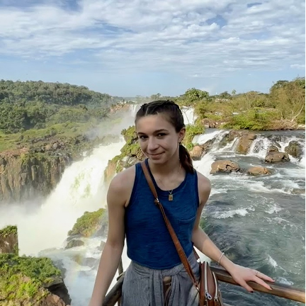 Natalie Harmon standing in front of a waterfall