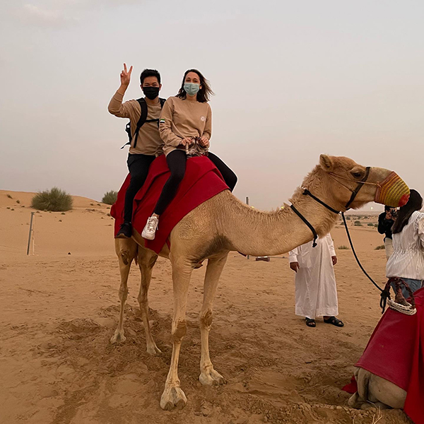 David Tran and friend sitting on a camel