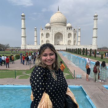 Woman stands in front of Taj Mahal