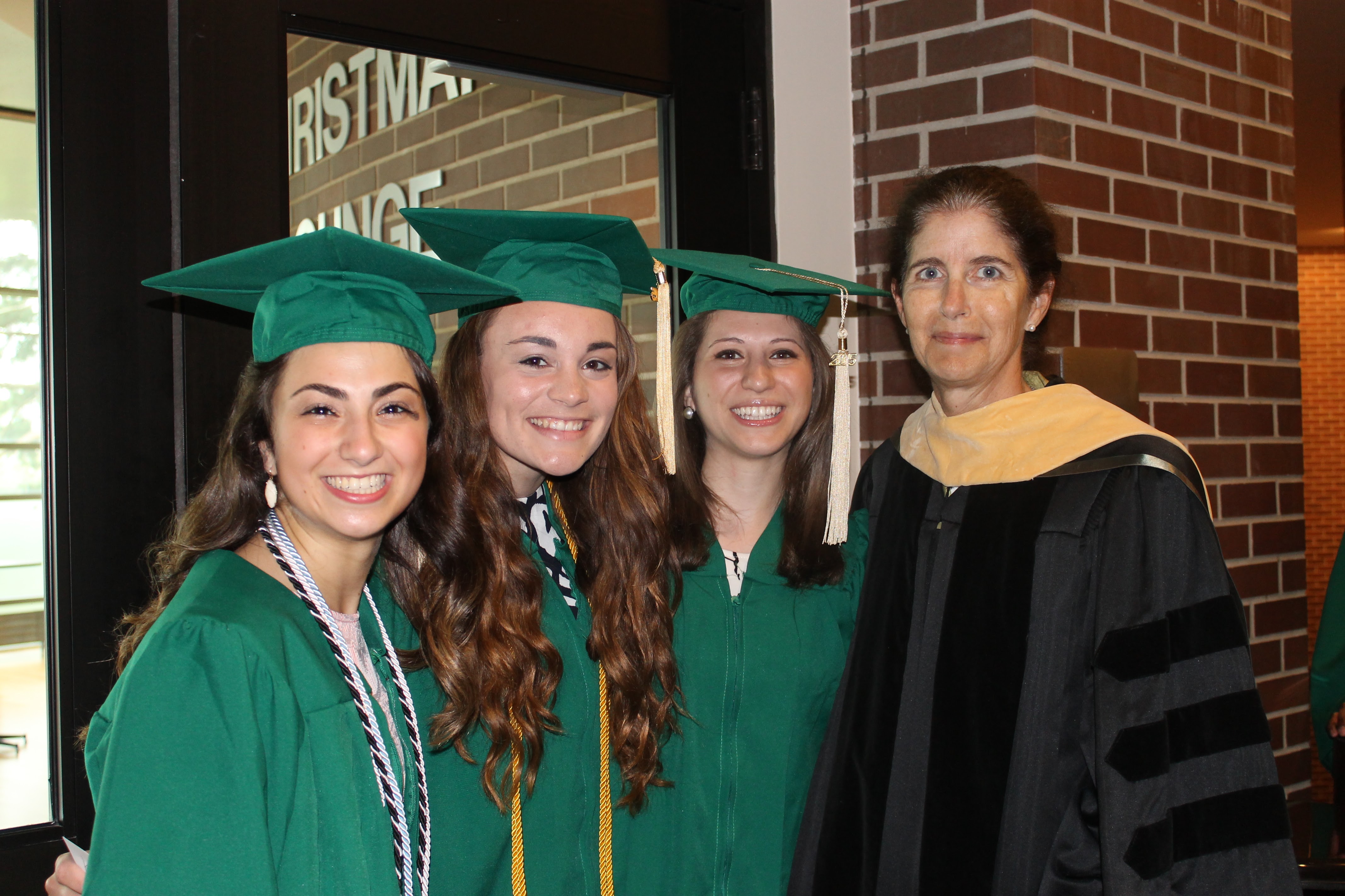 Connie Hunt with graduates in gowns