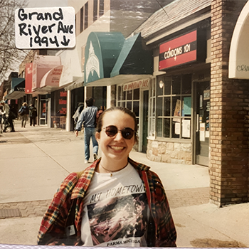 Erika Sponsler standing on the sidewalk along Grand River stores