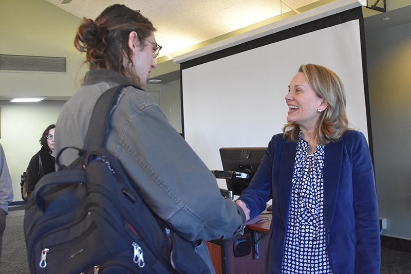 Ambassador Smith shakes a student's hand after her speaking engagement