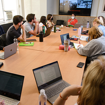 students seated around a large conference table